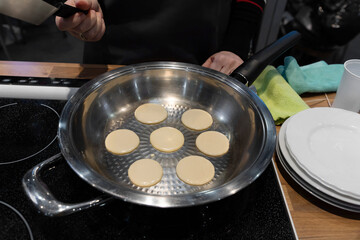 Frying mini pancake cereal in a nonstick frying pan.