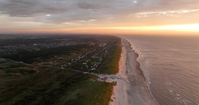 aerial drone video of sunset at the beach of Texel, Wadden island, sunset, golden hout, sand, sea, The Netherlands.