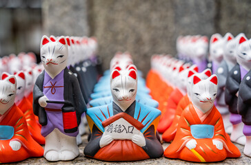 Many fox figurines and statues at Fushimi Inari Shrine, Kyoto Japan. ( Translation of the text from...
