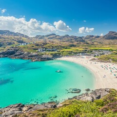 Fototapeta premium A scenic view of a turquoise beach surrounded by rocky hills and clear skies.