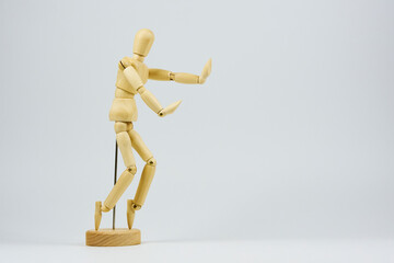 Wooden figure representing various dance movements demonstrating joy and ease