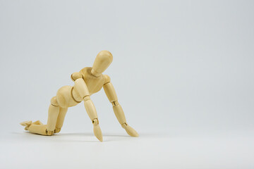 Articulated wooden figure representing the position of some type of physical exercise