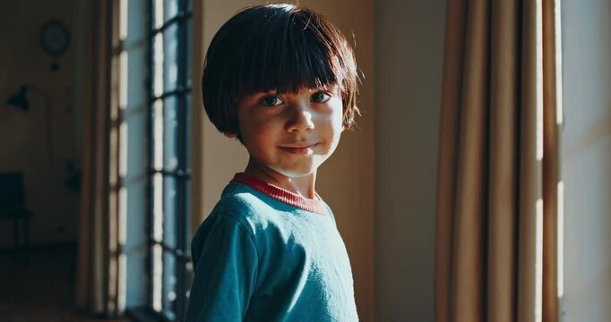 Portrait of a Thoughtful Young Boy in Natural Light by a Window in a Cozy Indoor Setting with Warm Atmosphere and Gentle Shadows