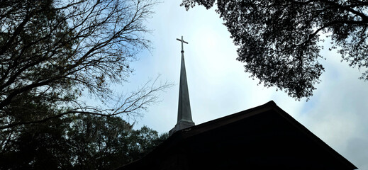 A church steeple with a cross at the top