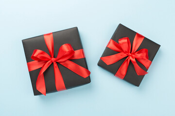 Black gift boxes on color background, top view. Black Friday concept