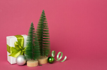 Small christmas trees with decoration on color background