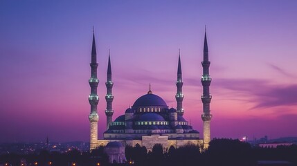 Fototapeta premium Illuminated Mosque Silhouette Against Vibrant Twilight Sky