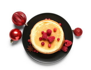 Plate of sweet pancakes with berries and Christmas balls on white background