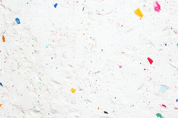 Abstract textured white surface with colorful paint specks