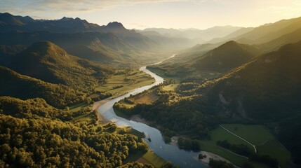 Breathtaking Aerial View of a Serene River Flowing Through Lush Green Valleys and Majestic Mountains at Sunrise