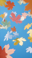 Obraz premium Colorful leaves falling against a blue sky, creating a vibrant autumn atmosphere.