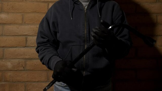 A threatening gangster holding a lug wrench