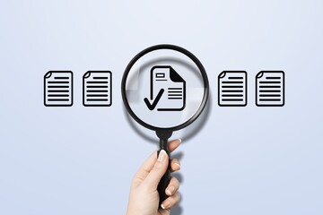 Document review and quality contro. Hand hold magnifying glass