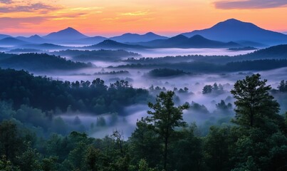 Mountain landscape at dawn with misty valleys and vibrant sky