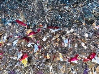 Happy new year background of shiny garlands of merry Christmas multicolored tinsel close-up