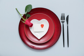 Beautiful table setting with red rose on grey background. Valentine's Day celebration