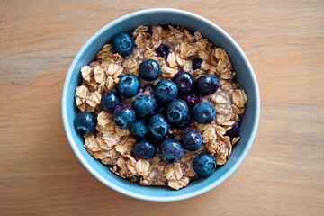 Morning delight of hearty oatmeal topped with fresh blueberries in a cozy kitchen