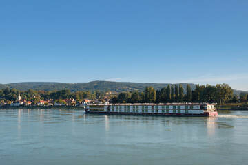 Cruise ship on dunabe river with Austrian village background
