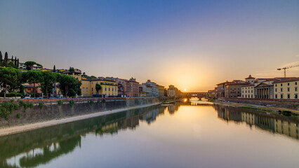 Fototapeta premium Sunset view of Florence Ponte Vecchio over Arno River in Florence timelapse, Italy.