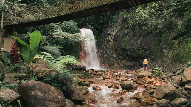 Red Rock Waterfalls with Bridge and Yellow Influencer