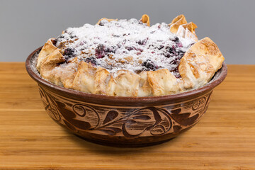 Baked sweet cottage cheese casserole in flat bread in bowl