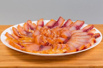 Sliced different cold smoked freshwater fish on plate, close-up