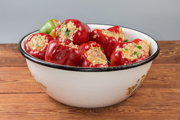 Raw stuffed bell pepper in kitchen bowl on rustic table