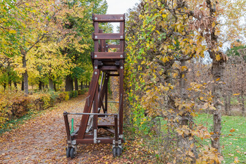 Wooden towable cart used for hedge trimming in park