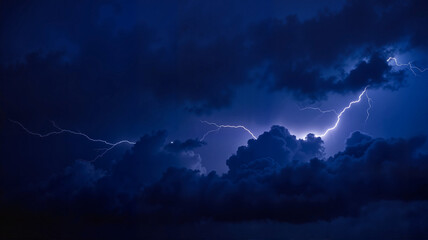 Dramatic night sky with lightning in dark storm clouds