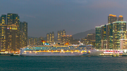 Skyline panorama timelapse day to night with towers and ship in West Kowloon, Hong Kong.