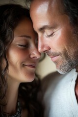 Couple's intimate moment, eyes closed, foreheads touching.