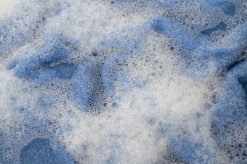 Blue Wool Sweater Being Hand Washed in Soapy Water