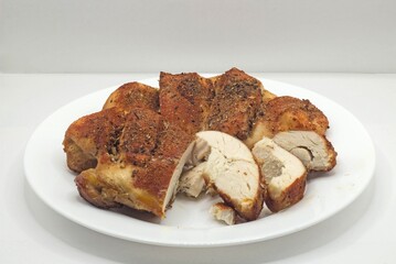 grilled chicken legs and roasted chicken on plate