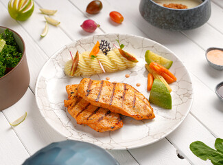 Tender, golden grilled chicken steak  and fresh seasoning. Ideal for healthy, delicious meals , With mashed potatoes, zucchini and carrots