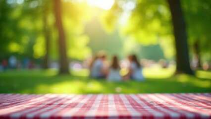 Friends gather on a checkered blanket for a picnic in the park. The sun shines brightly, creating a warm atmosphere while others enjoy the day in the background