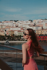 Young woman in a pink suit against the backdrop of Sunset Town in Vietnam