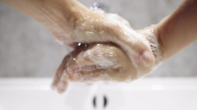 A close-up of hands washing their hands with soap emphasizes hygiene, cleanliness and self-care. The concept of freshness and hygiene rules. 