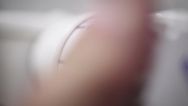 A hand adjusting the heating radiator as cold weather sets in, seeking warmth and comfort at home. A concept highlighting seasonal changes, home heating, and energy efficiency for winter.