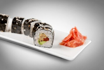 Fresh tasty sushi rolls on plate