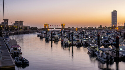 Yachts and boats at the Sharq Marina night to day timelapse in Kuwait. Kuwait City, Middle East