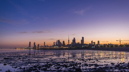 Fototapeta premium Seaside skyline of Kuwait city from night to day timelapse
