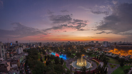 Aerial view to Park of the Reserve with magic water circuit biggest fountain complex day to night timelapse