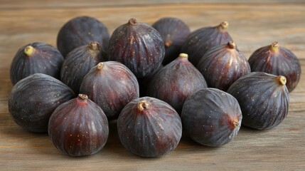 Fototapeta premium Fresh figs clustered on a wooden surface.