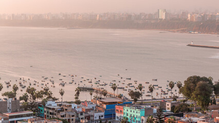 Fototapeta premium Aerial view of Lima's shoreline with boats including the districts of Barranco and Chorrillos timelapse. Peru