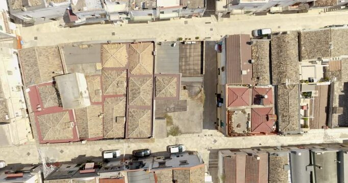 Aerial perpendicular view of houses, apartments and buildings located in the historic center of the town of Bernalda, in the province of Matera, Basilicata, Italy. It is a traditional Italian village.