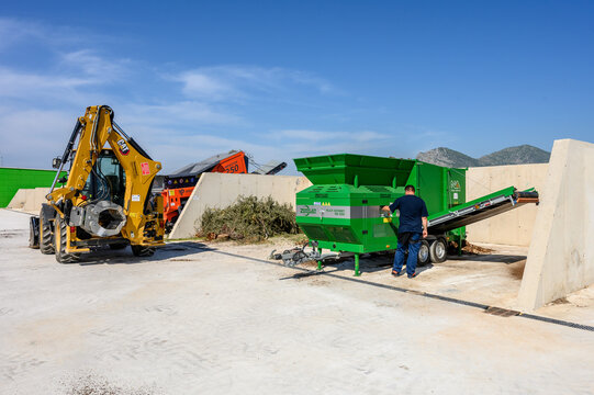 Industrial Composting Facility with Heavy Machinery and Compost Piles