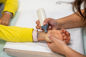 Physiotherapist applies wrist and hand massages for rehabilitation