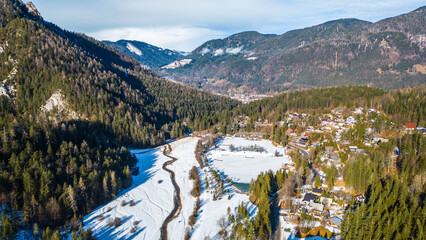 Jezero Jasna, a stunning alpine lake near Kranjska Gora, Slovenia, is a magical sight in winter when its surface freezes and the surrounding peaks are covered in snow