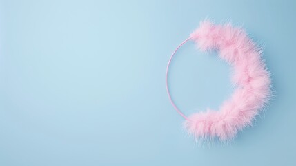 Naklejka premium Pink feather headband on blue background, fluffy hair accessory, minimalist studio shot, ample copy space on left, soft and delicate design, pastel color palette, simple and clean aesthetic, top down 