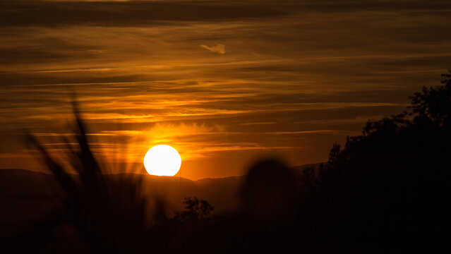 People admiring the sunset timelapse near Temple of Debod Park in Madrid.